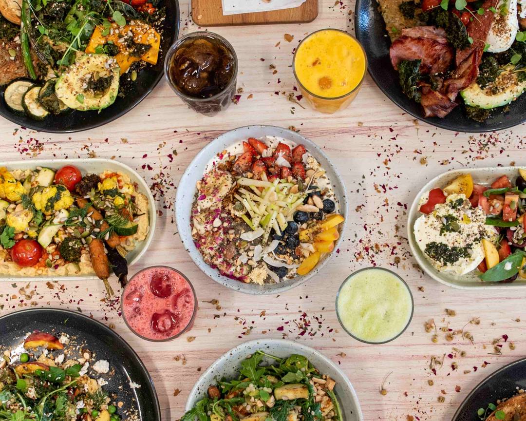A spread of seasonal brunch dishes, fresh juices and bowls